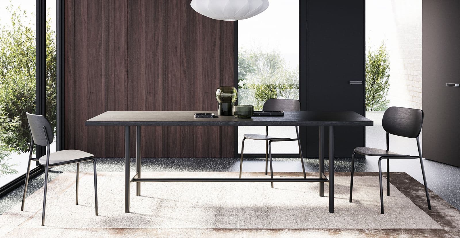 Elegant long Frank table made of dark wood in a modern kitchen, surrounded by chairs, with decorative items and a stylish white lamp.