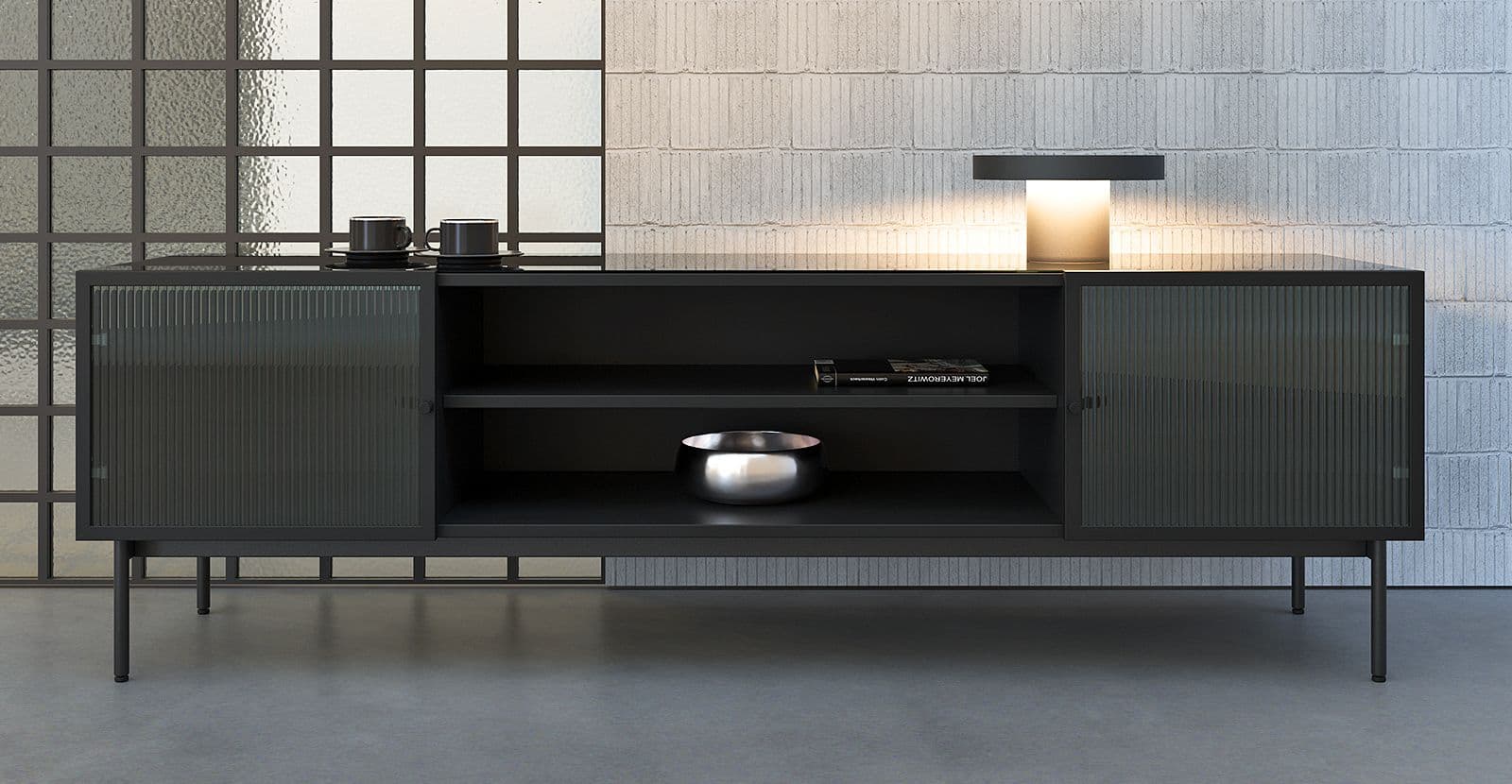 Stylish low Leon cabinet made of dark material with ribbed glass doors in a modern interior, decorated with a lamp and decorative items